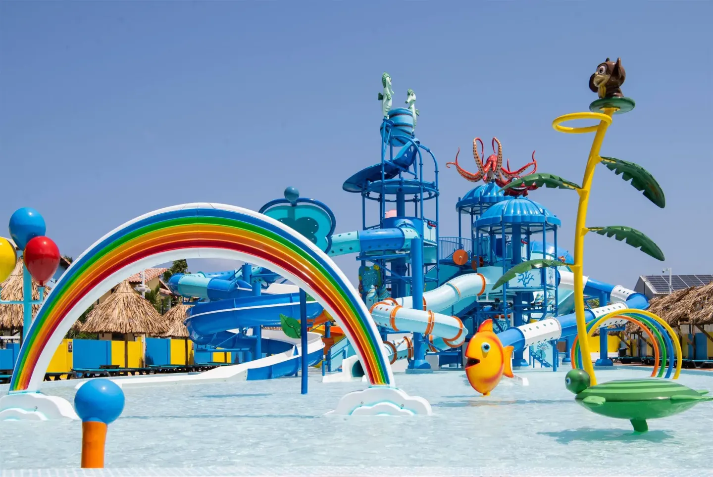 Colorful splash playground with slides and rainbow arches at Kunuku Resort Curacao.
