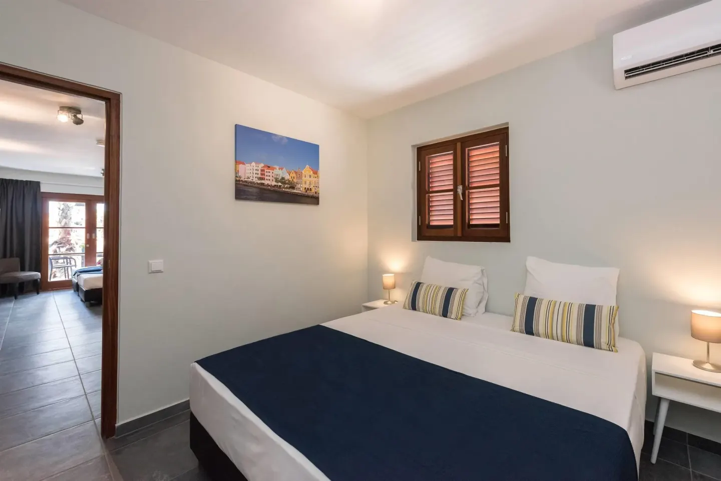 Family Quadruple Room double bed and doorway at Kunuku Resort Curacao.