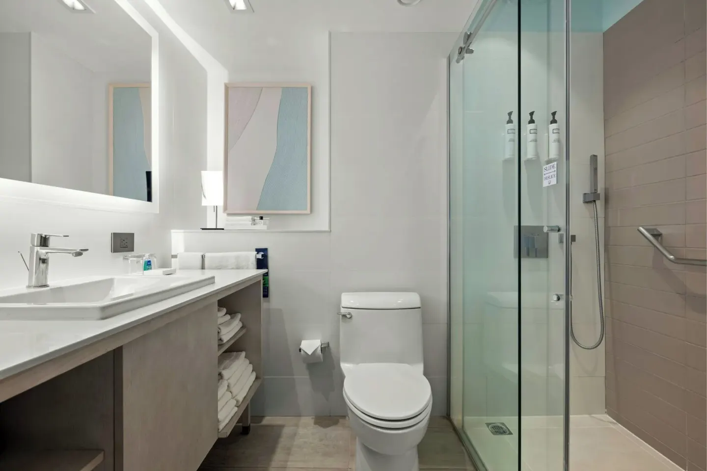 Modern bathroom with glass shower and lit mirror at La Concha Resort, Puerto Rico.