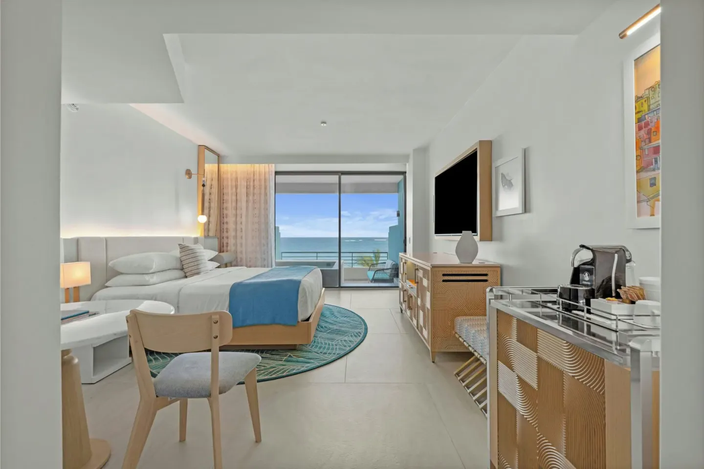 Ocean-view king bed room with TV and refreshment area at La Concha Resort, Puerto Rico.