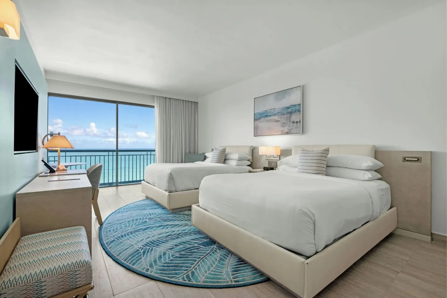 Two-bed ocean-view guest room with desk at La Concha Resort, Puerto Rico.