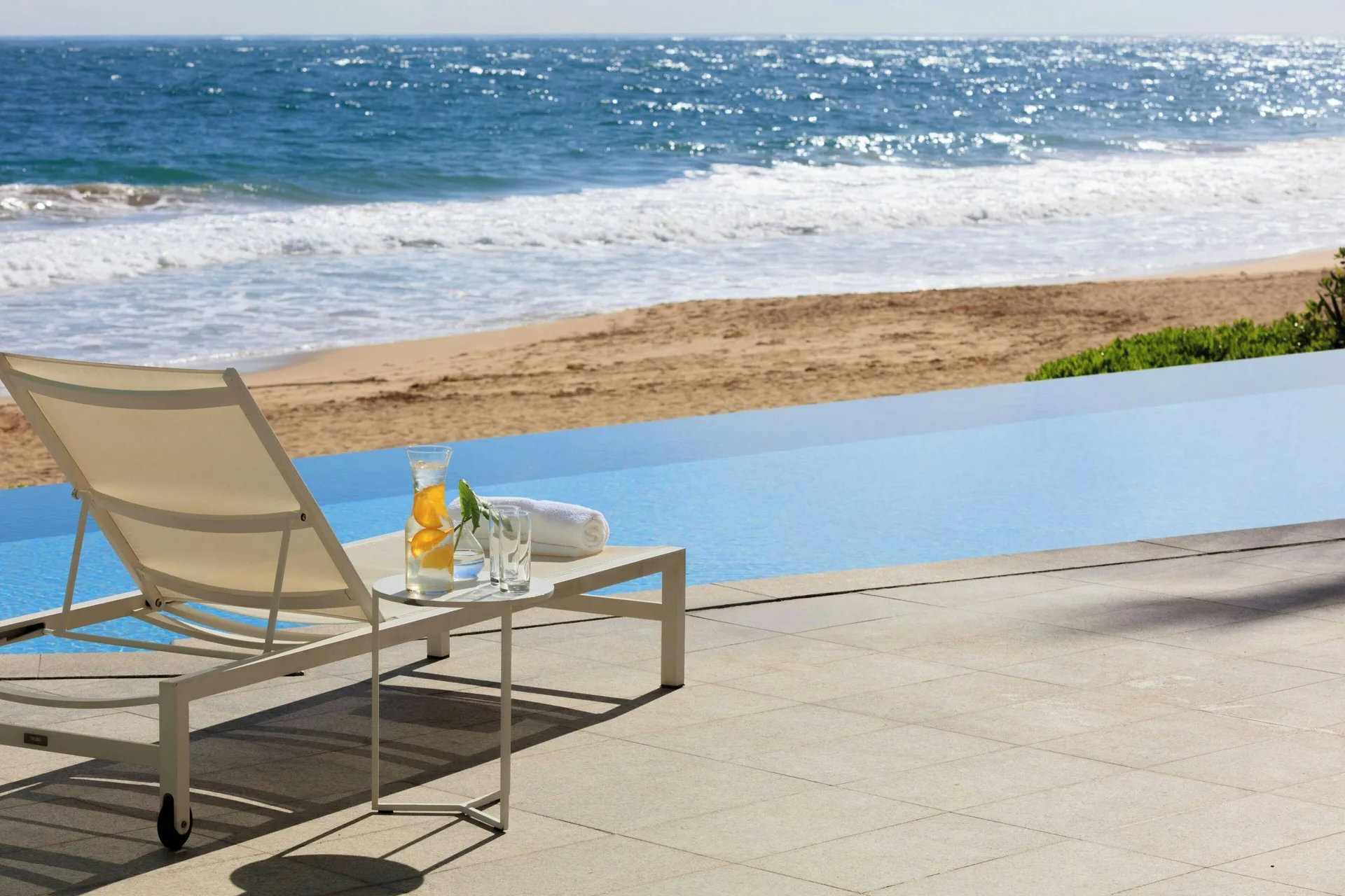 Oceanfront lounge chair beside an infinity pool at La Concha Resort, Puerto Rico.