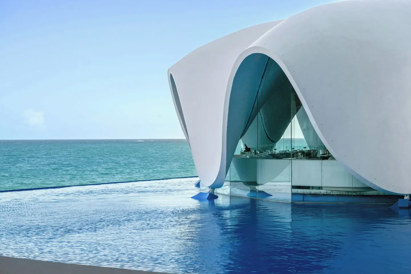 Oceanfront pool and white shell-like pavilion at La Concha Resort, Puerto Rico.