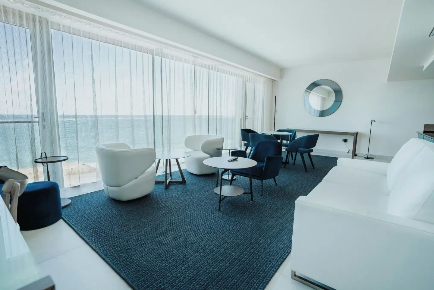 Oceanfront suite lounge with white seating and blue chairs at La Concha Resort, Puerto Rico.