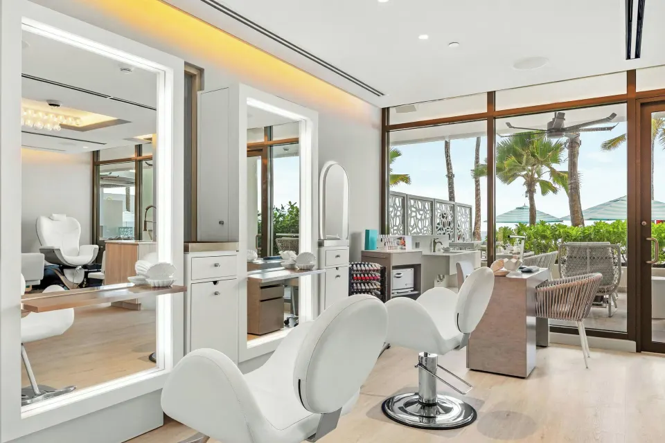 Salon stations with white chairs and large mirrors at La Concha Resort, Puerto Rico.