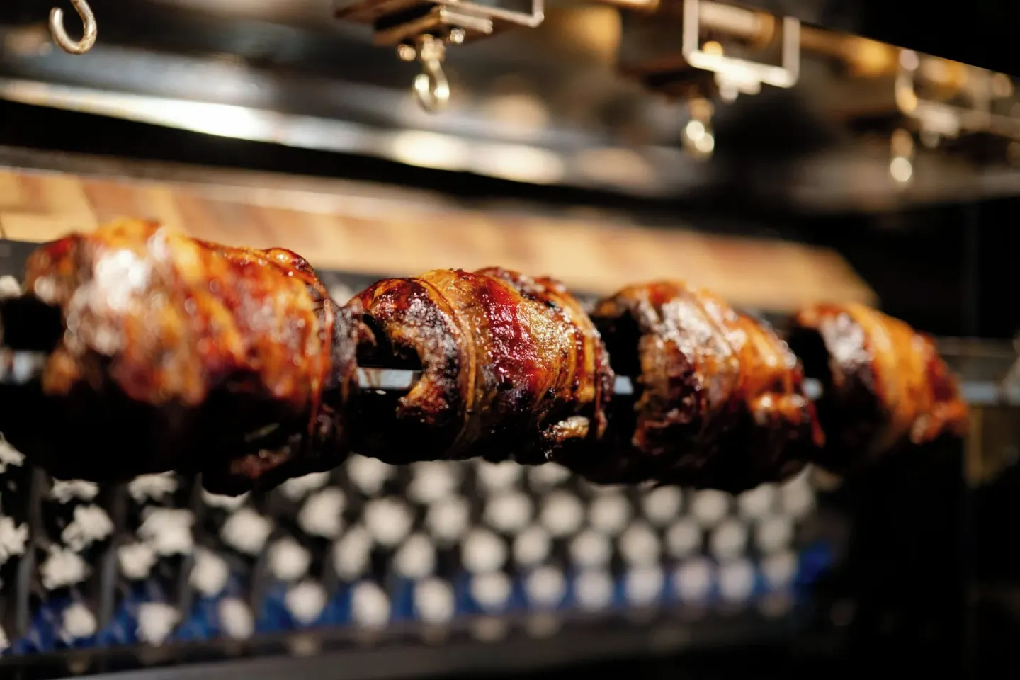 Rotisserie meats cook over flames at La Concha Resort, Puerto Rico.