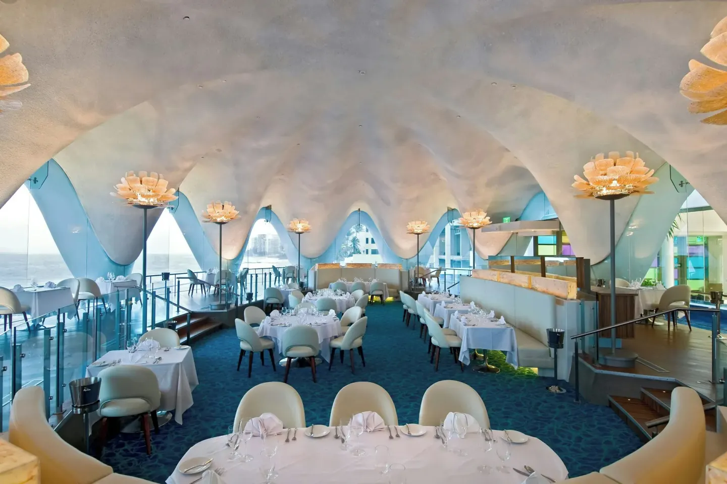 Ocean-view dining room with white table settings at La Concha Resort, Puerto Rico.