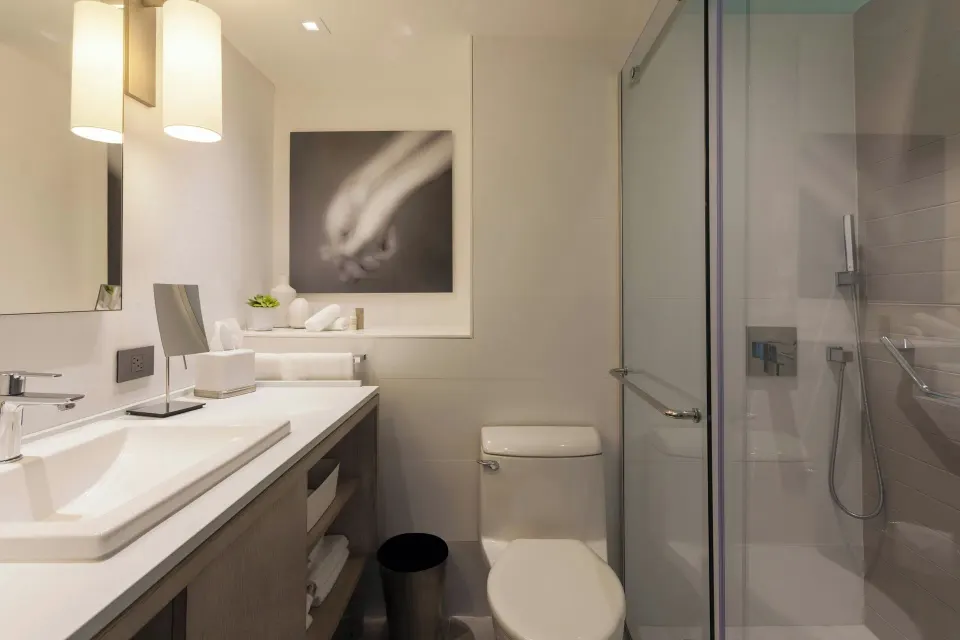 Deluxe Ocean View bathroom with vanity, toilet and glass shower at La Concha Resort, Puerto Rico.