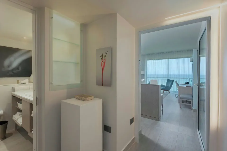 Deluxe Ocean View entry hall with bathroom vanity and room beyond at La Concha Resort, Puerto Rico.