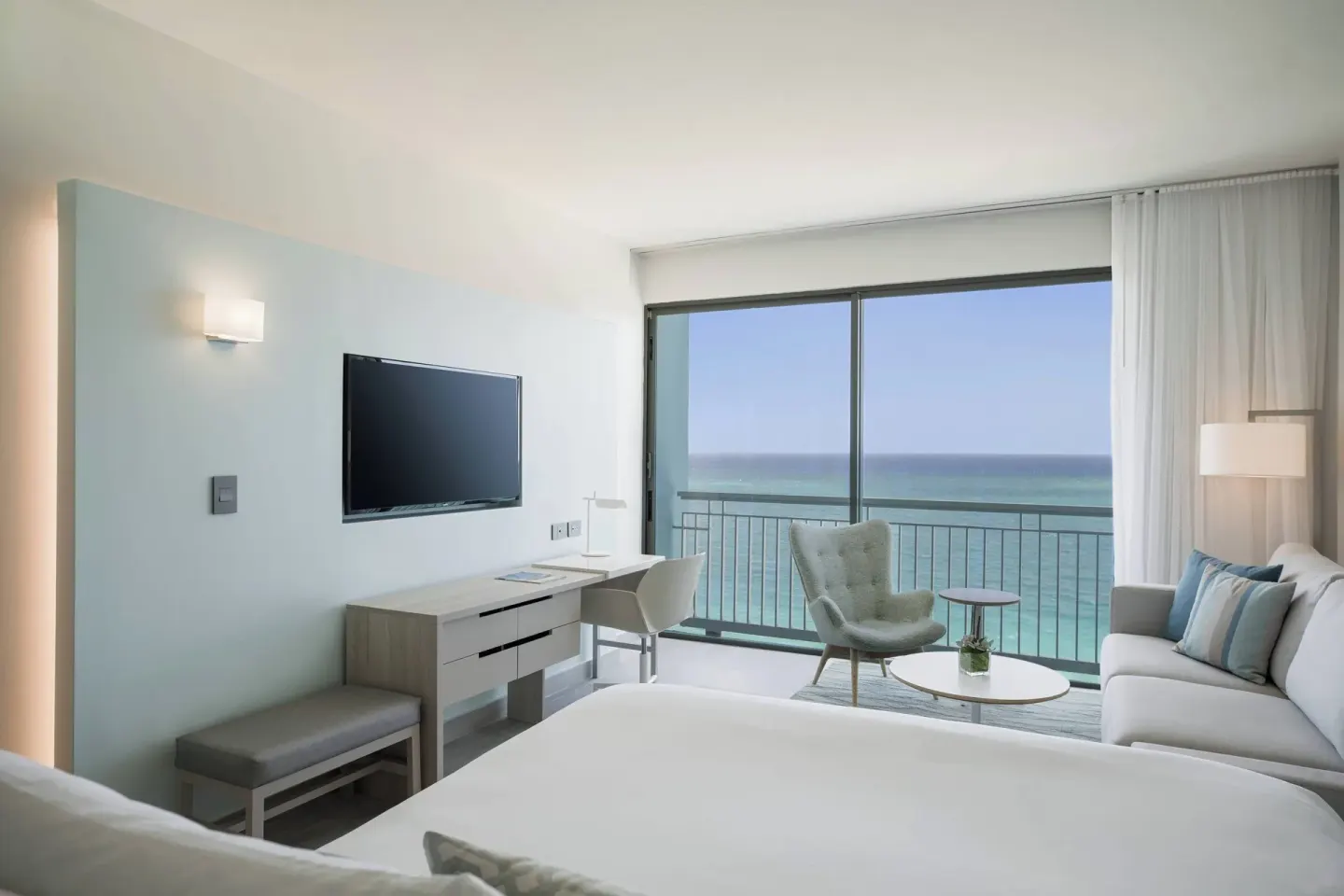 Deluxe Ocean View room with bed, sofa, desk and balcony at La Concha Resort, Puerto Rico.