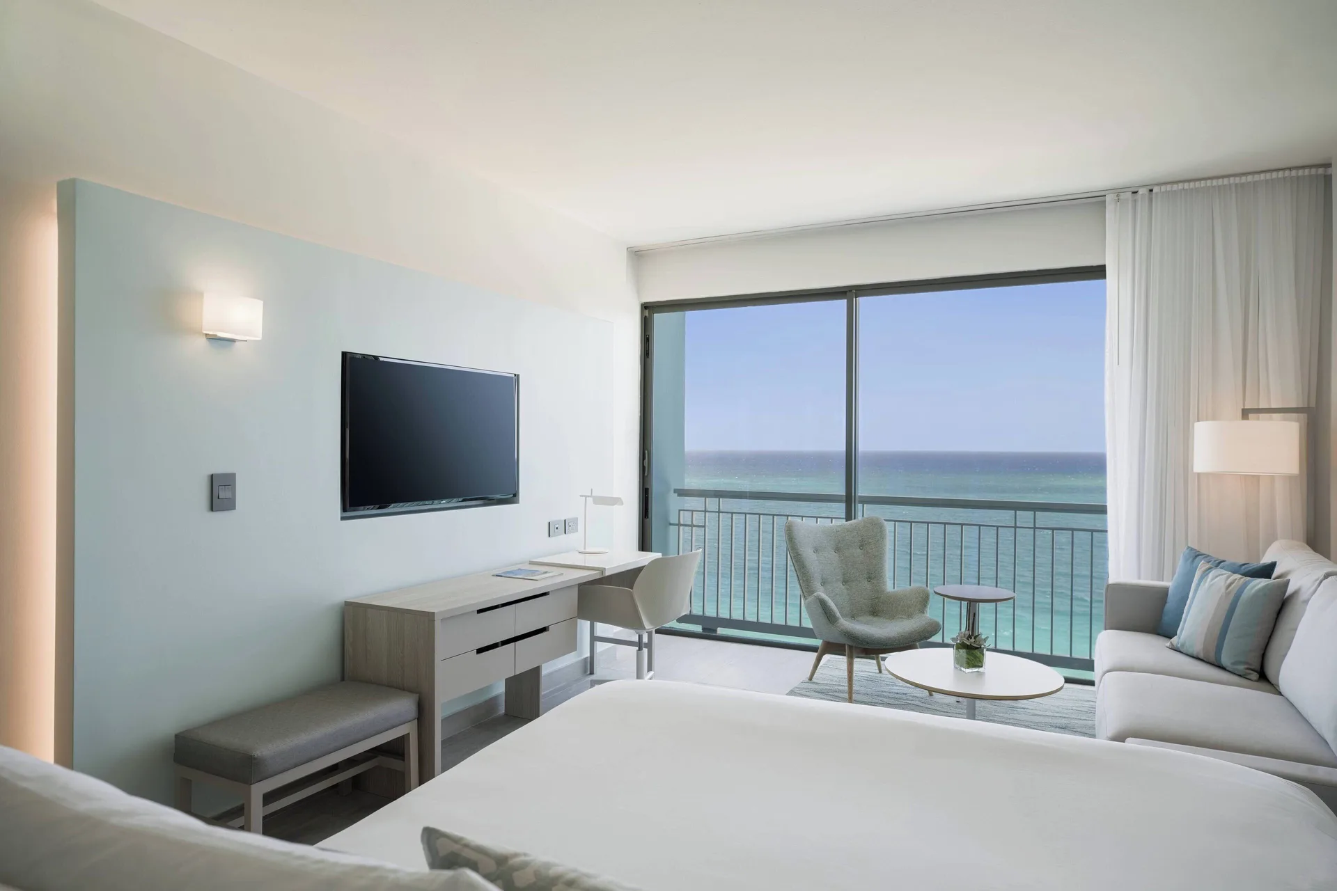Deluxe Ocean View room with bed, sofa, desk and balcony at La Concha Resort, Puerto Rico.