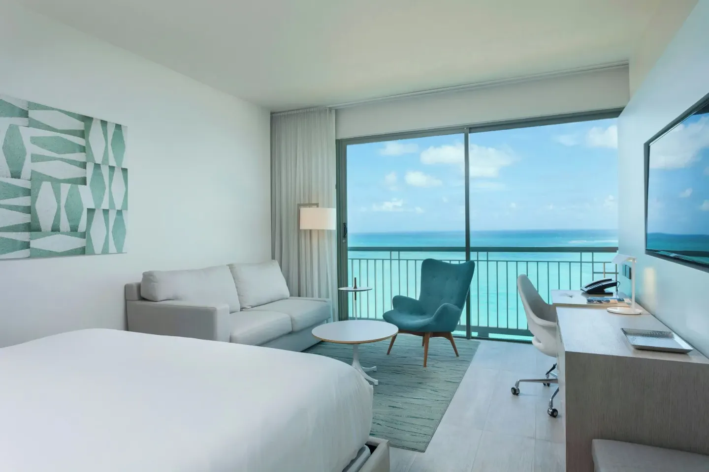Deluxe Ocean View room with king bed, sofa, blue chair and desk at La Concha Resort, Puerto Rico.