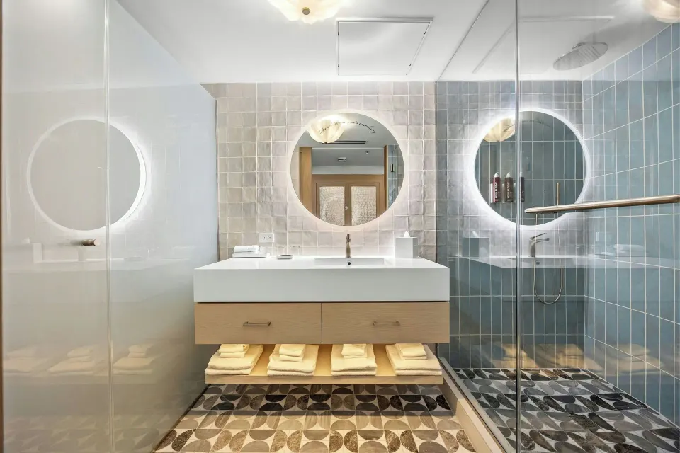 Deluxe Suite bathroom vanity and glass shower at La Concha Resort, Puerto Rico.