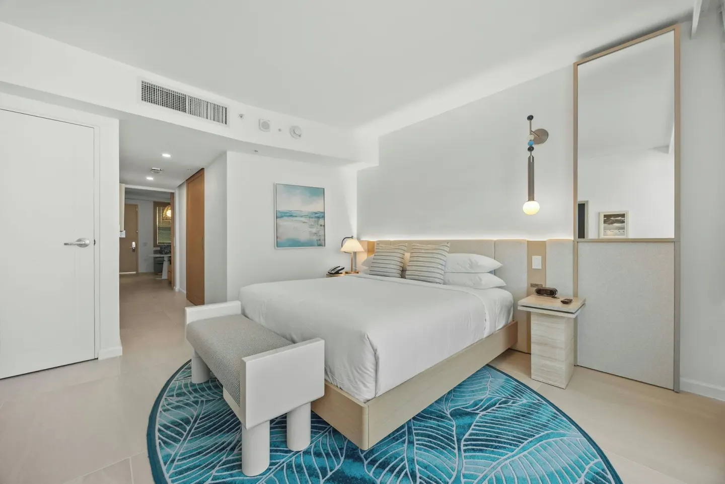 Deluxe Suite bedroom with king bed and teal rug at La Concha Resort, Puerto Rico.