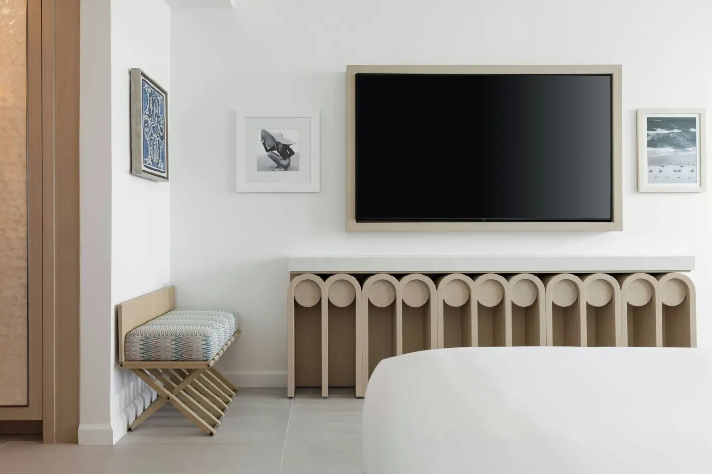 Deluxe Suite bedroom TV wall and luggage bench at La Concha Resort, Puerto Rico.