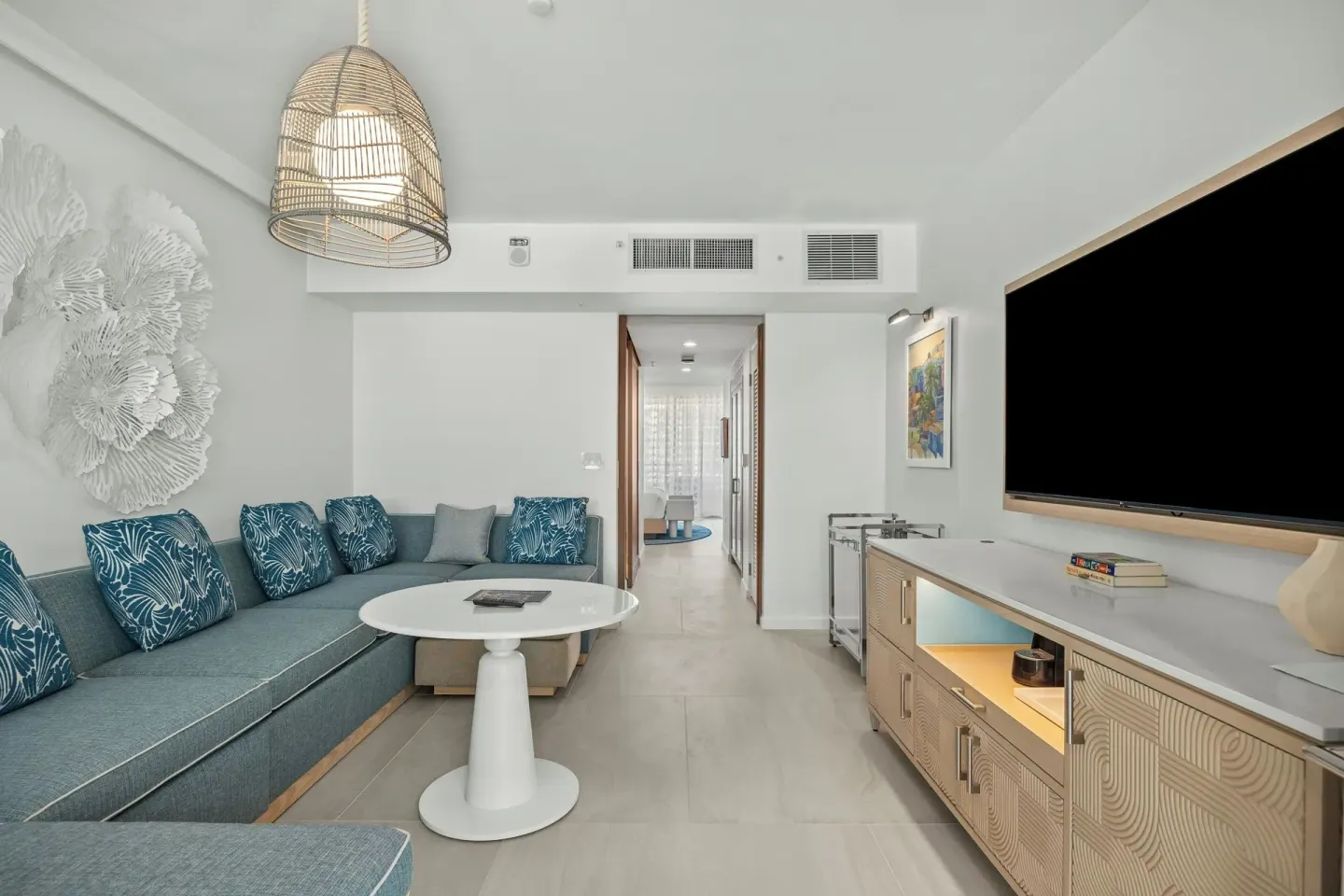 Deluxe Suite living room with sectional sofa and TV at La Concha Resort, Puerto Rico.