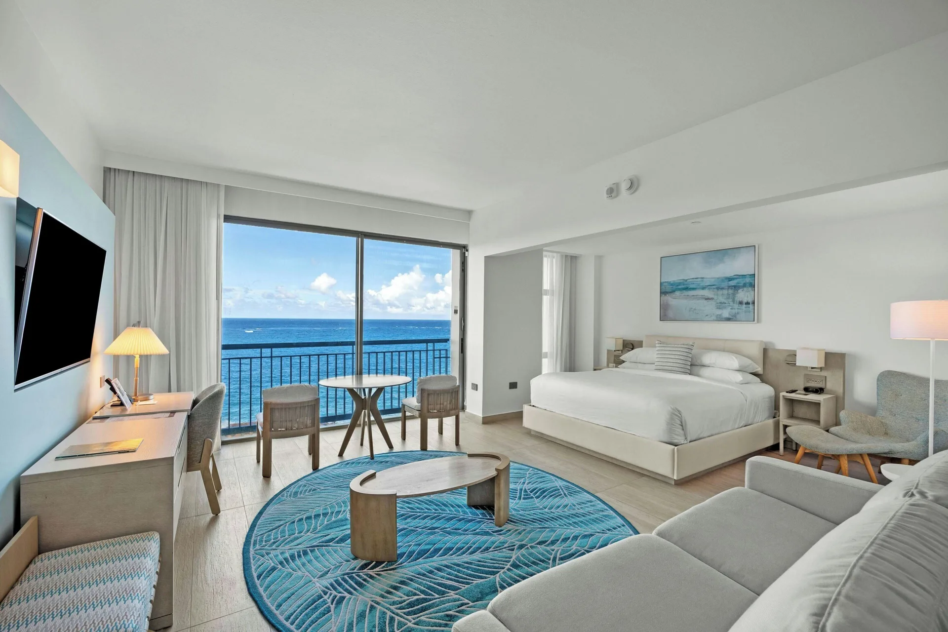 Junior Suite at La Concha Resort Puerto Rico with king bed, sofa bed, balcony seating, and ocean view ambiance in Condado, San Juan.