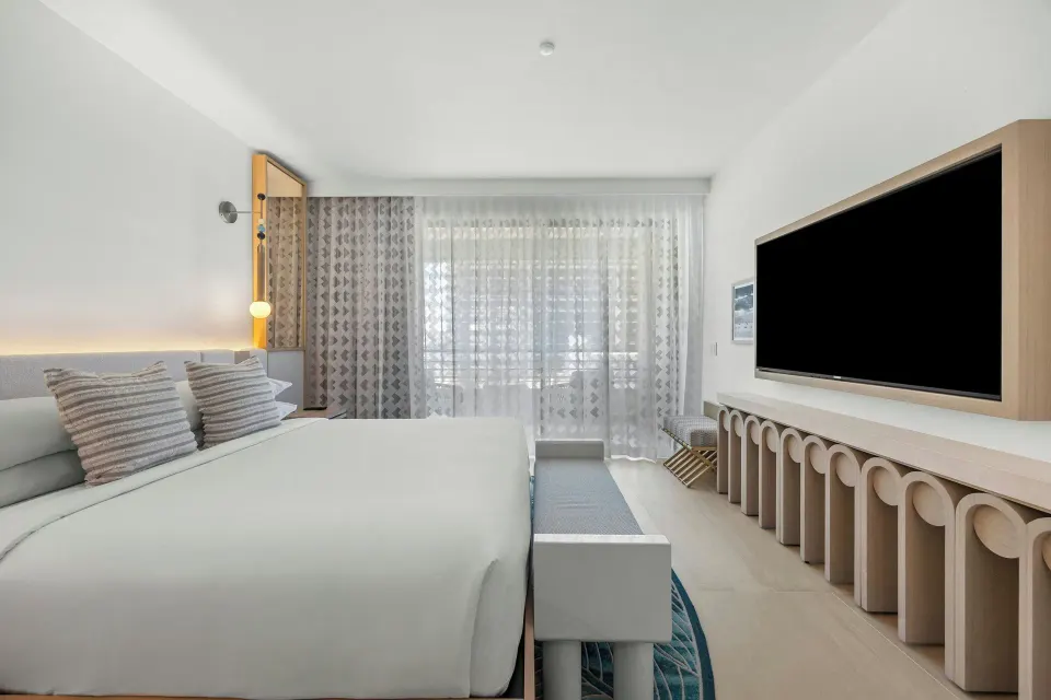 City View corner room with king bed, balcony doors, and wall-mounted TV at La Concha Resort, Puerto Rico.