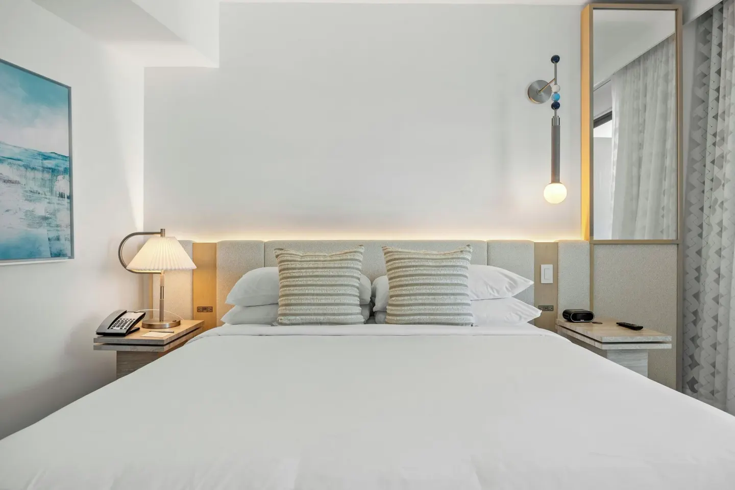King bed with bedside lamps in a City View corner room at La Concha Resort, Puerto Rico.