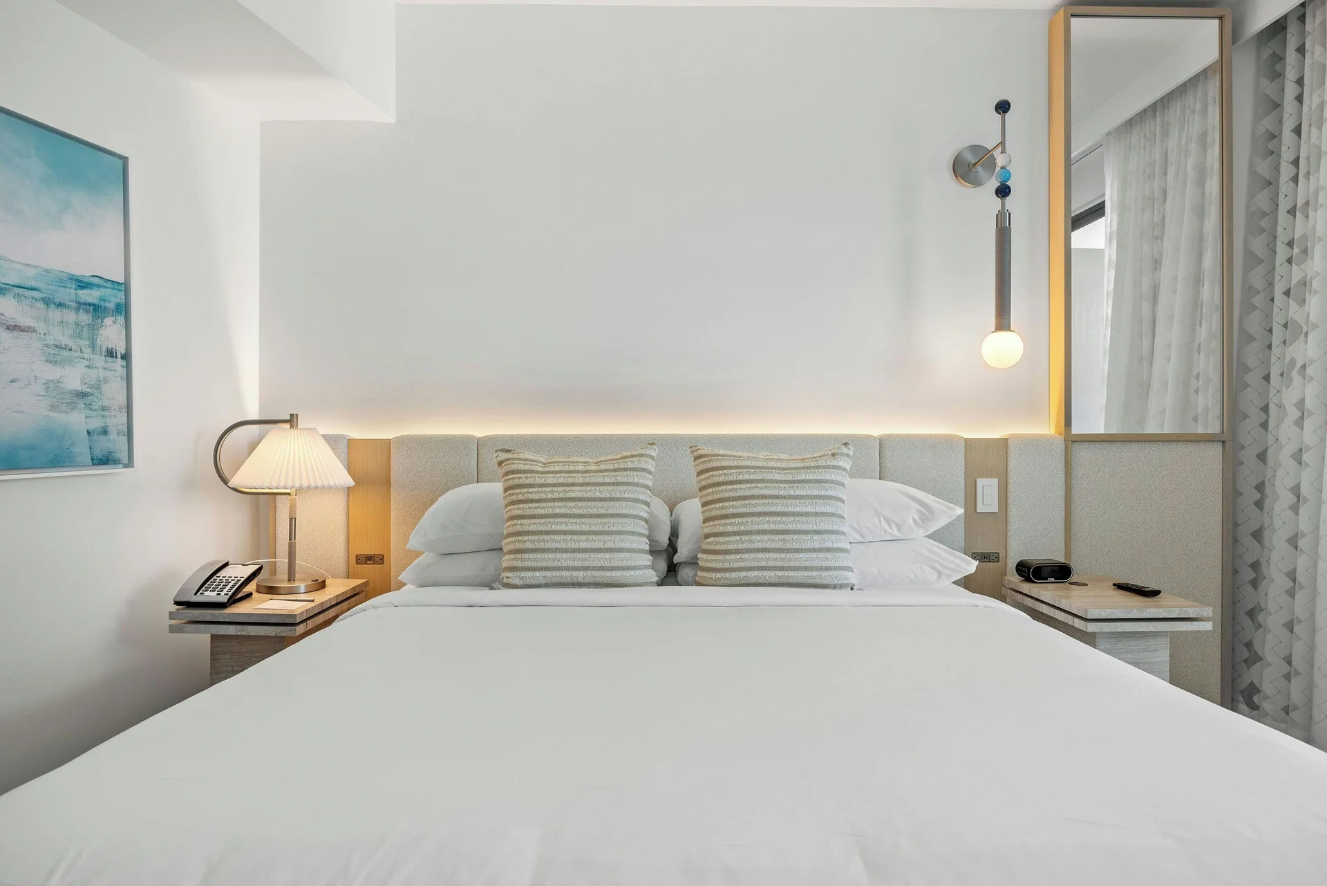 King bed with bedside lamps in a City View corner room at La Concha Resort, Puerto Rico.