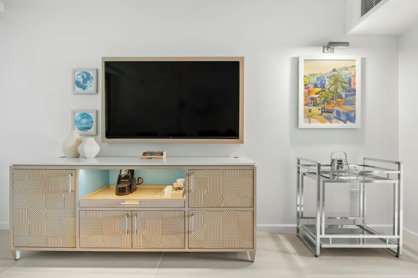 Guest room media cabinet with TV, coffee setup, and bar cart at La Concha Resort, Puerto Rico.