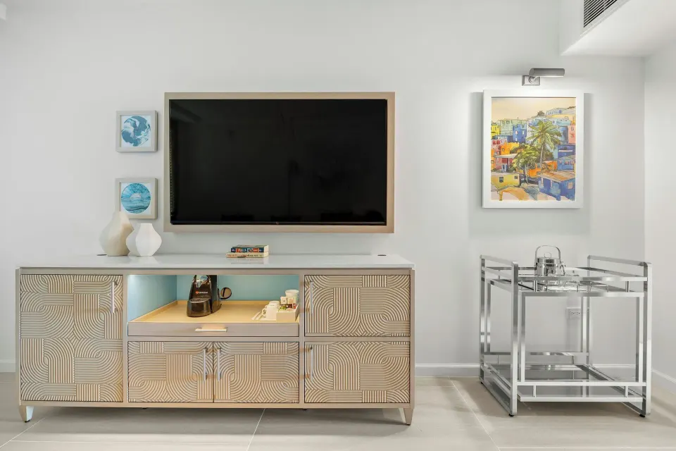 Guest room media cabinet with TV, coffee setup, and bar cart at La Concha Resort, Puerto Rico.