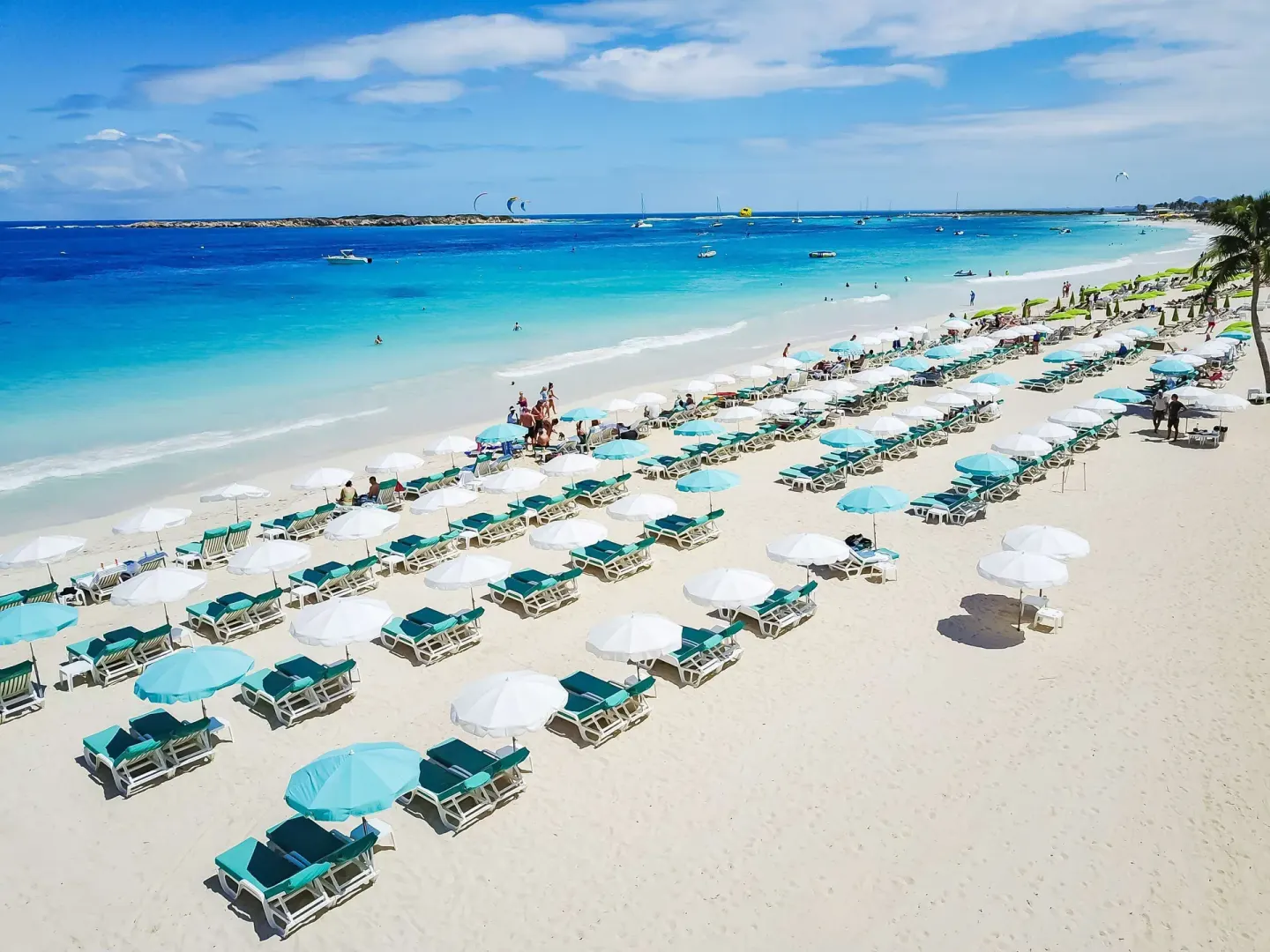 Aerial view of beach loungers and umbrellas at La Playa Orient Bay.