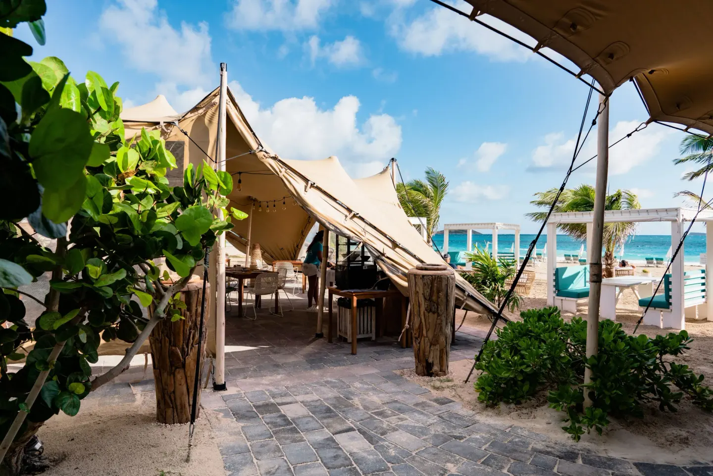 Tent-covered beach walkway and cabanas at La Playa Orient Bay.