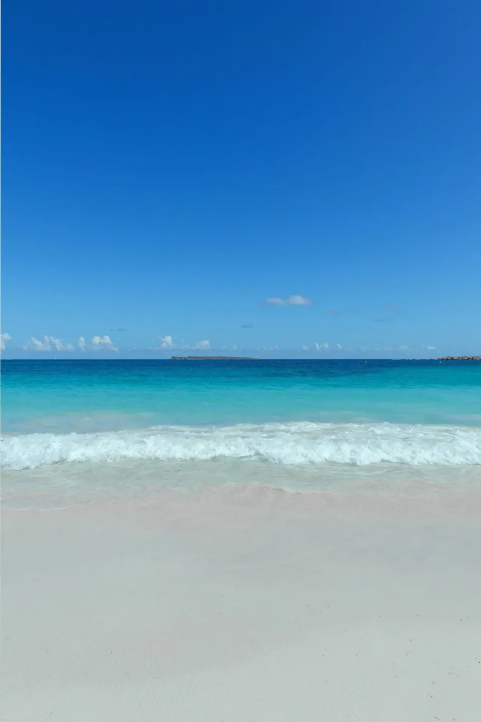 Soft surf and turquoise water on the beach at La Playa Orient Bay.