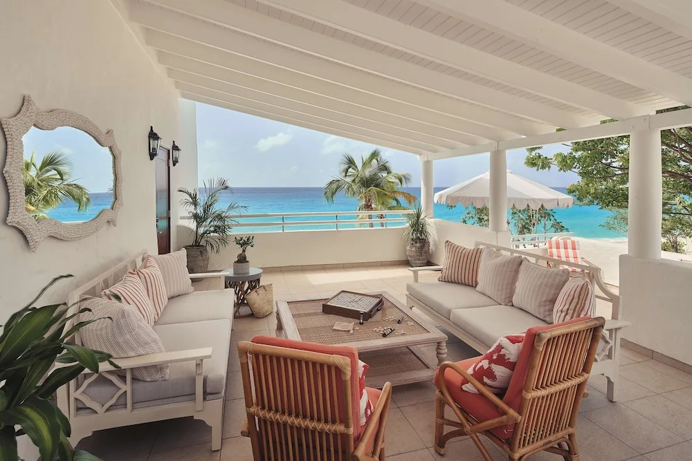 Open-air terrace lounge with sofas and an ocean view at La Samanna, St Martin.