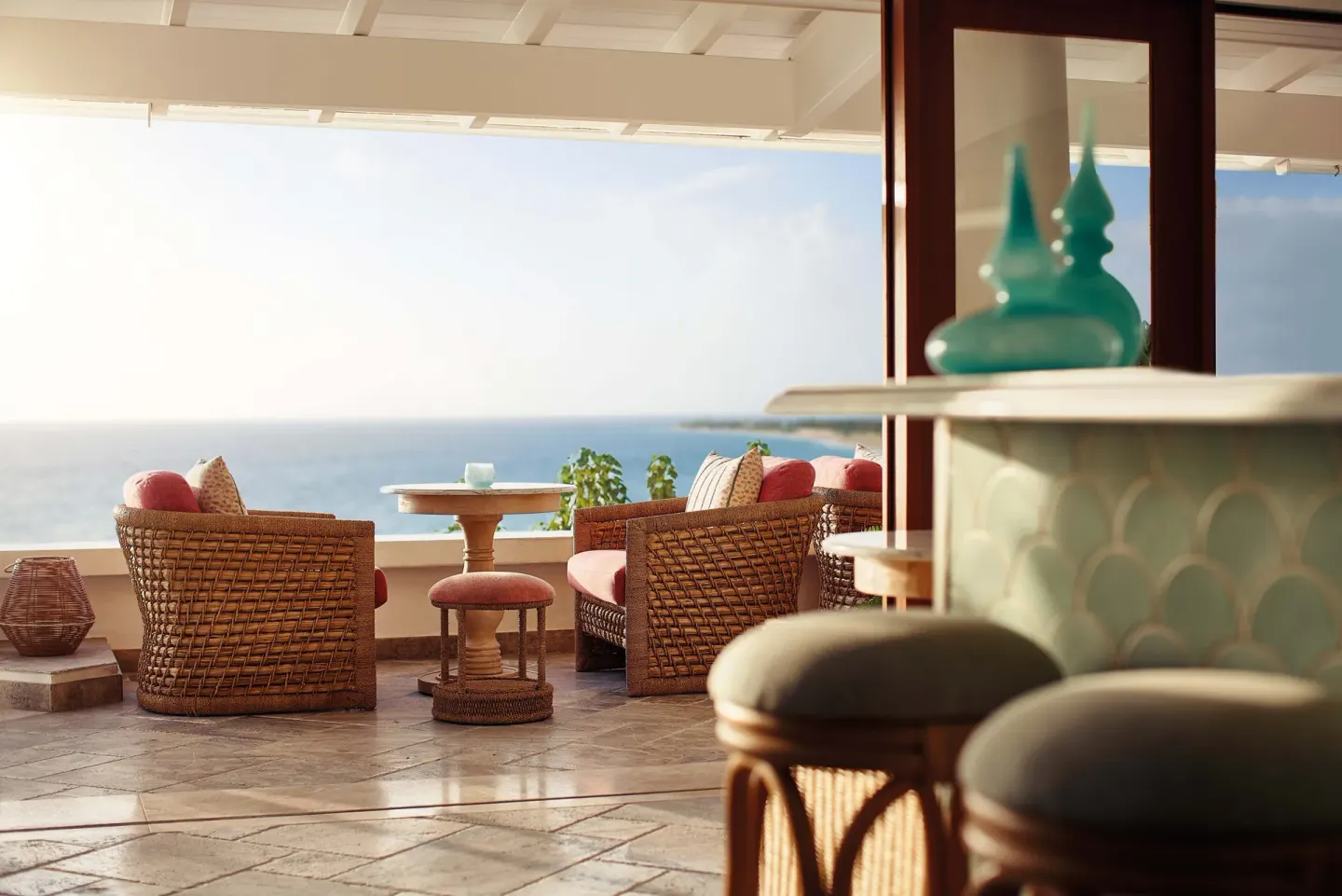 Open-air lounge with wicker seating and an ocean view at La Samanna, St Martin.