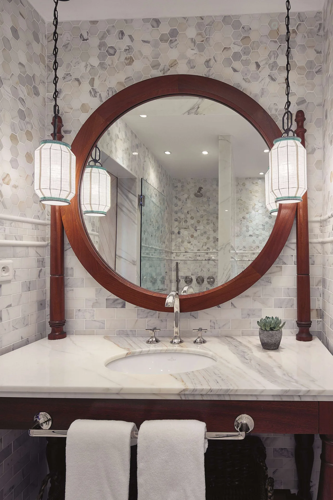 Deluxe Room Ocean View bathroom vanity with round mirror at La Samanna, St Martin.