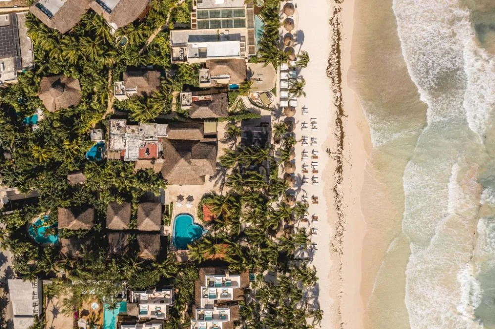 Ana y Jose Hotel & Spa Tulum established upscale beachfront hotel and spa with palapa roofs and sandy shoreline in Tulum, Mexico.