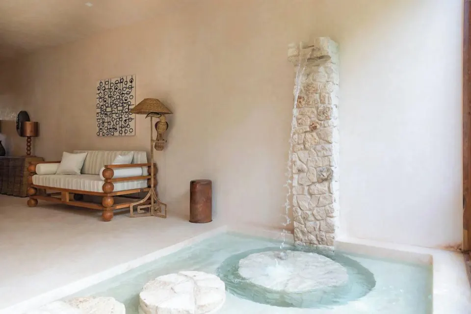 Close-up of indoor plunge pool feature and seating in a Junior Suite at La Valise Tulum.