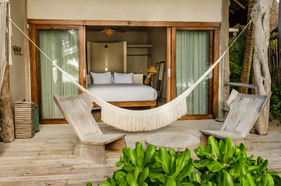 Hammock and lounge chairs on the deck outside a beachfront room at La Valise Tulum