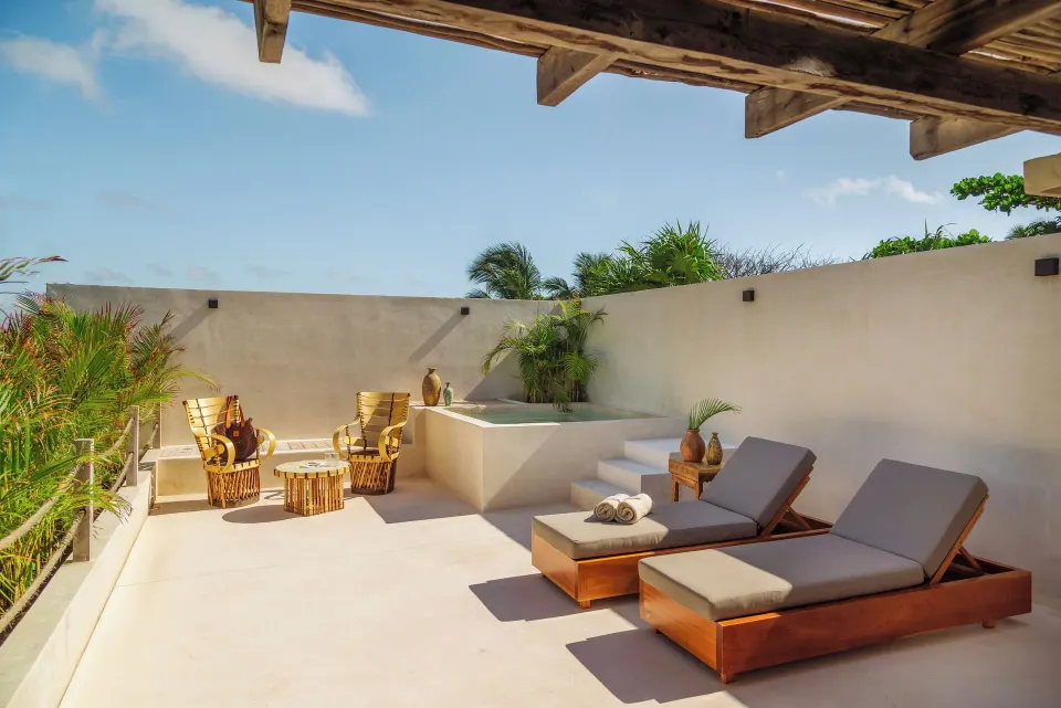 Private rooftop terrace with loungers and seating in the Cenote Master Suite at La Valise Tulum