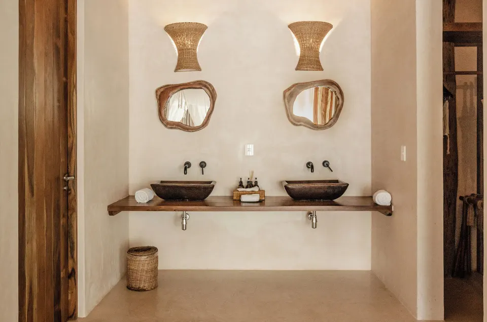 Double vanity with two vessel sinks and decorative mirrors in the Garden Suite Upper at La Valise Tulum.