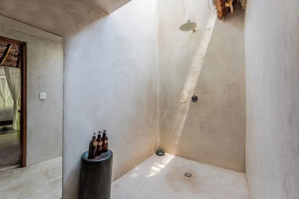 Minimalist outdoor-style shower with rainfall head in the Garden View Room at La Valise Tulum.