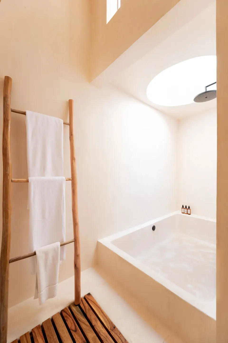 Bathroom with a deep soaking tub and rainfall shower in a Junior Room at La Valise Tulum.