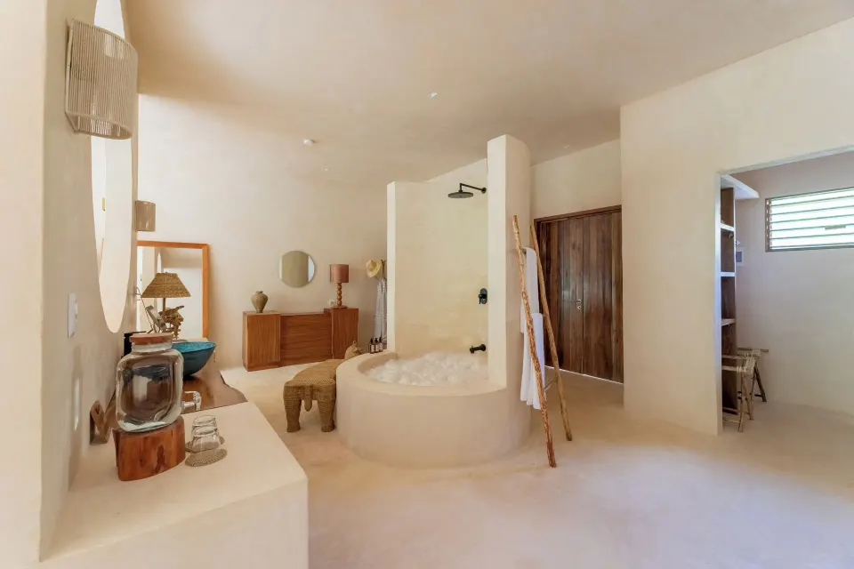 Open bathroom with round tub, walk-in shower and wood vanity in Signature Suite at La Valise Tulum