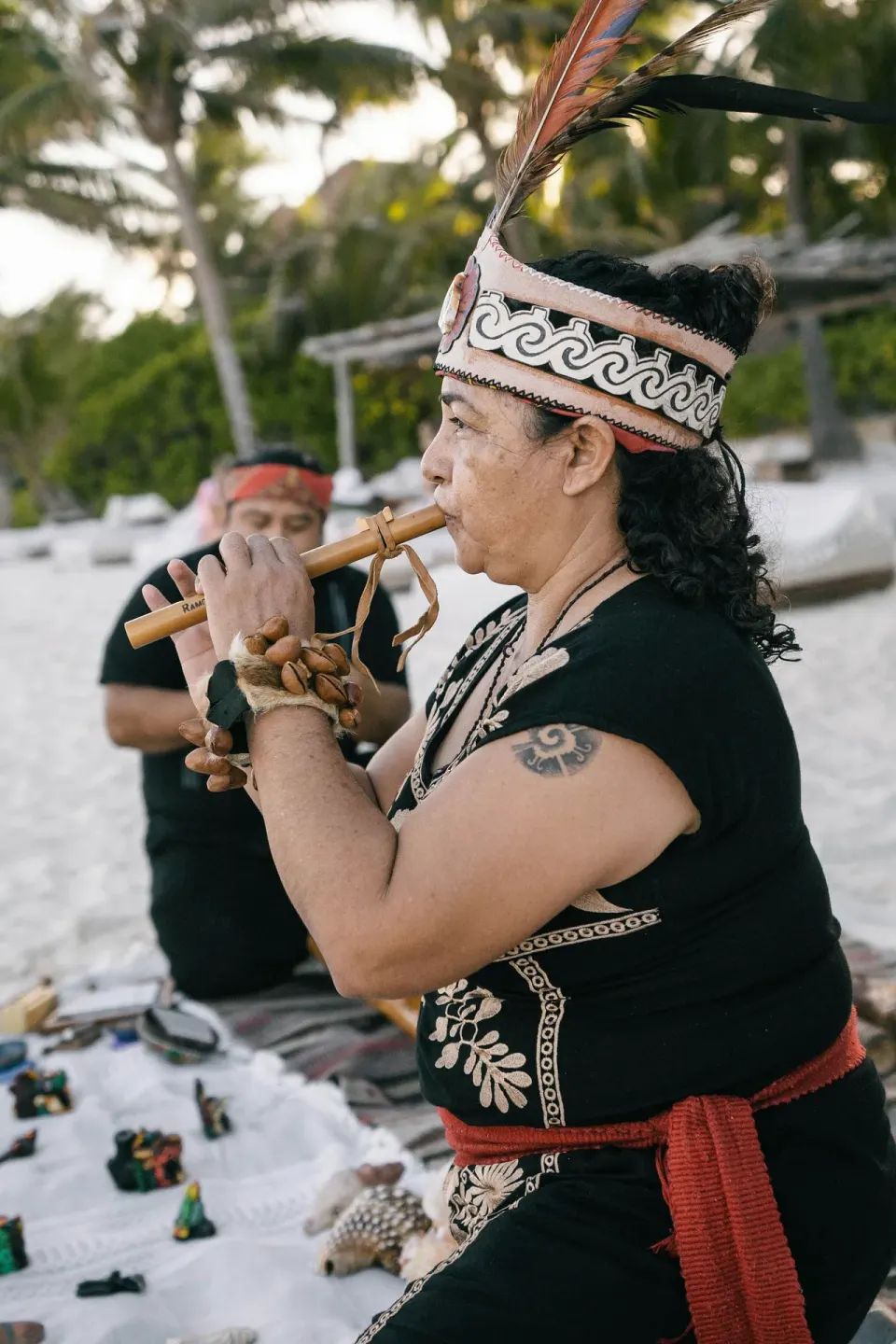 Musician playing flute on the beach at La Valise Tulum.