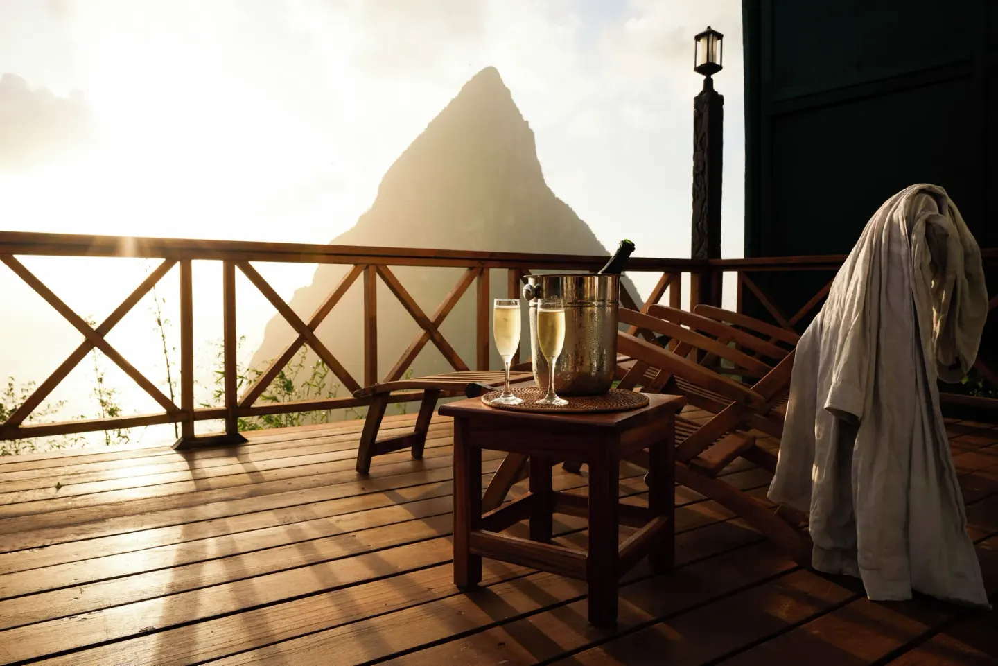 Wooden deck with loungers, robes, drinks and a Piton view at Ladera Resort.