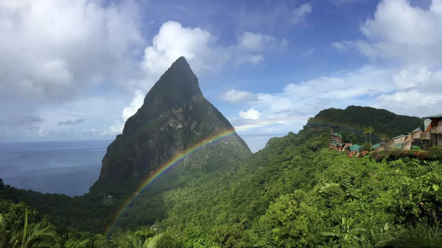 Rainbow over a Piton and green hillside at Ladera Resort.