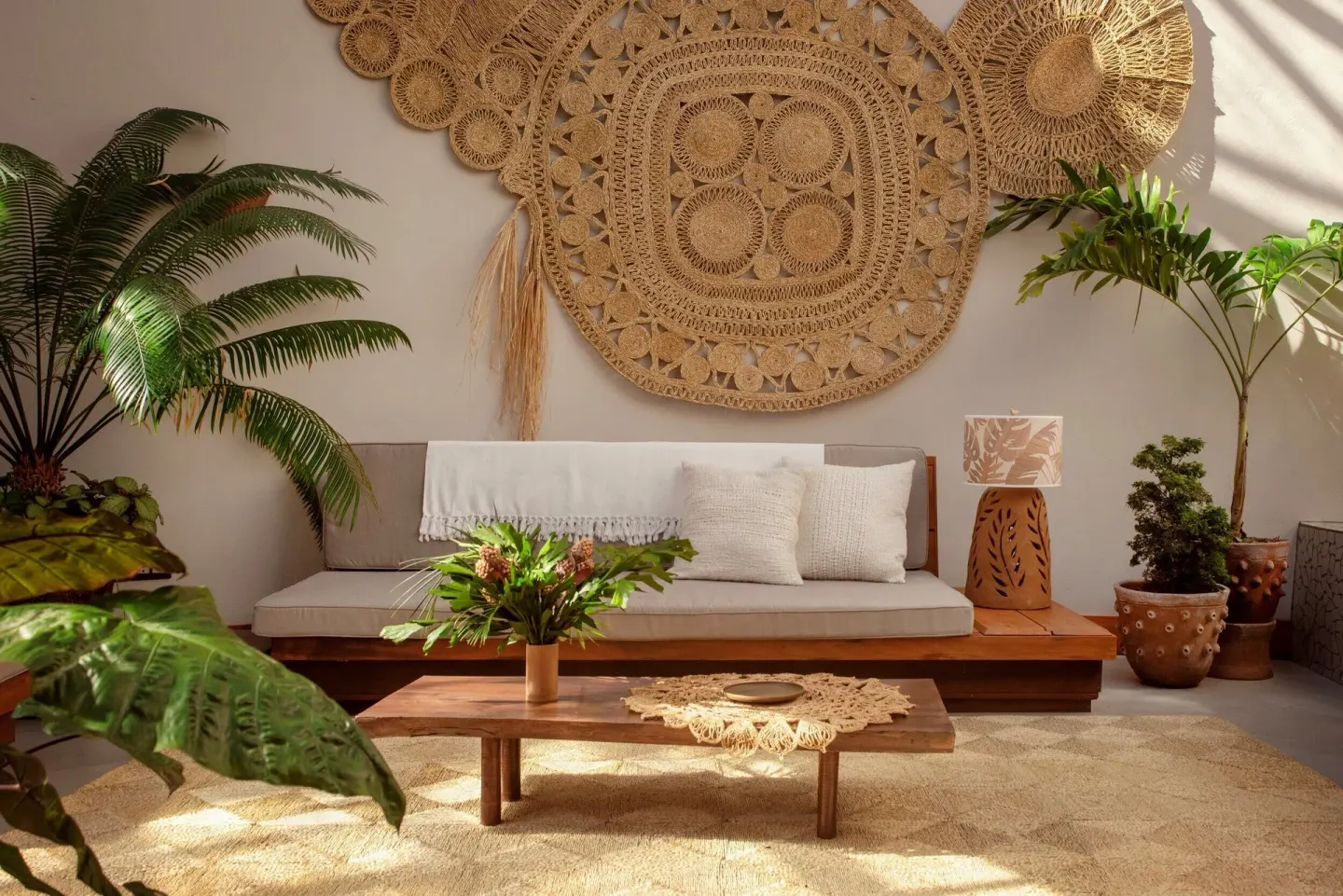 Sunlit lounge seating with woven wall art and plants at Ladera Resort.