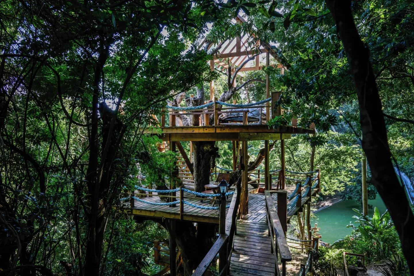 Wooden tree deck and walkway in lush tropical grounds at Ladera Resort.