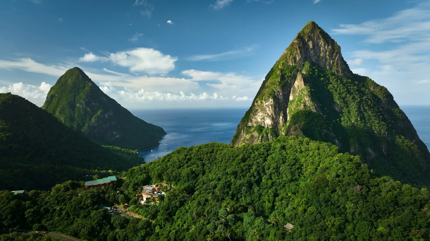 Twin Pitons, ocean, and forested hills viewed from Ladera Resort.