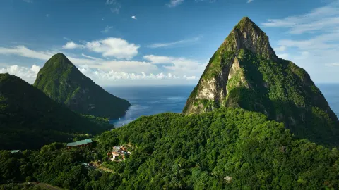 Twin Pitons, ocean, and forested hills viewed from Ladera Resort.