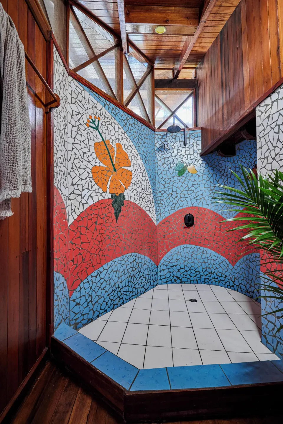 Colorful tiled shower with floral mosaic in the Gros Piton Suite at Ladera Resort.
