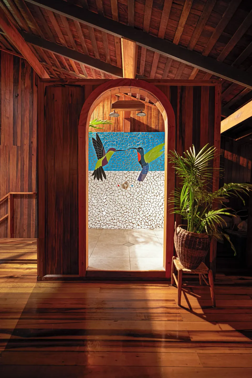 Heritage Suite shower entrance with hummingbird mosaic at Ladera Resort.