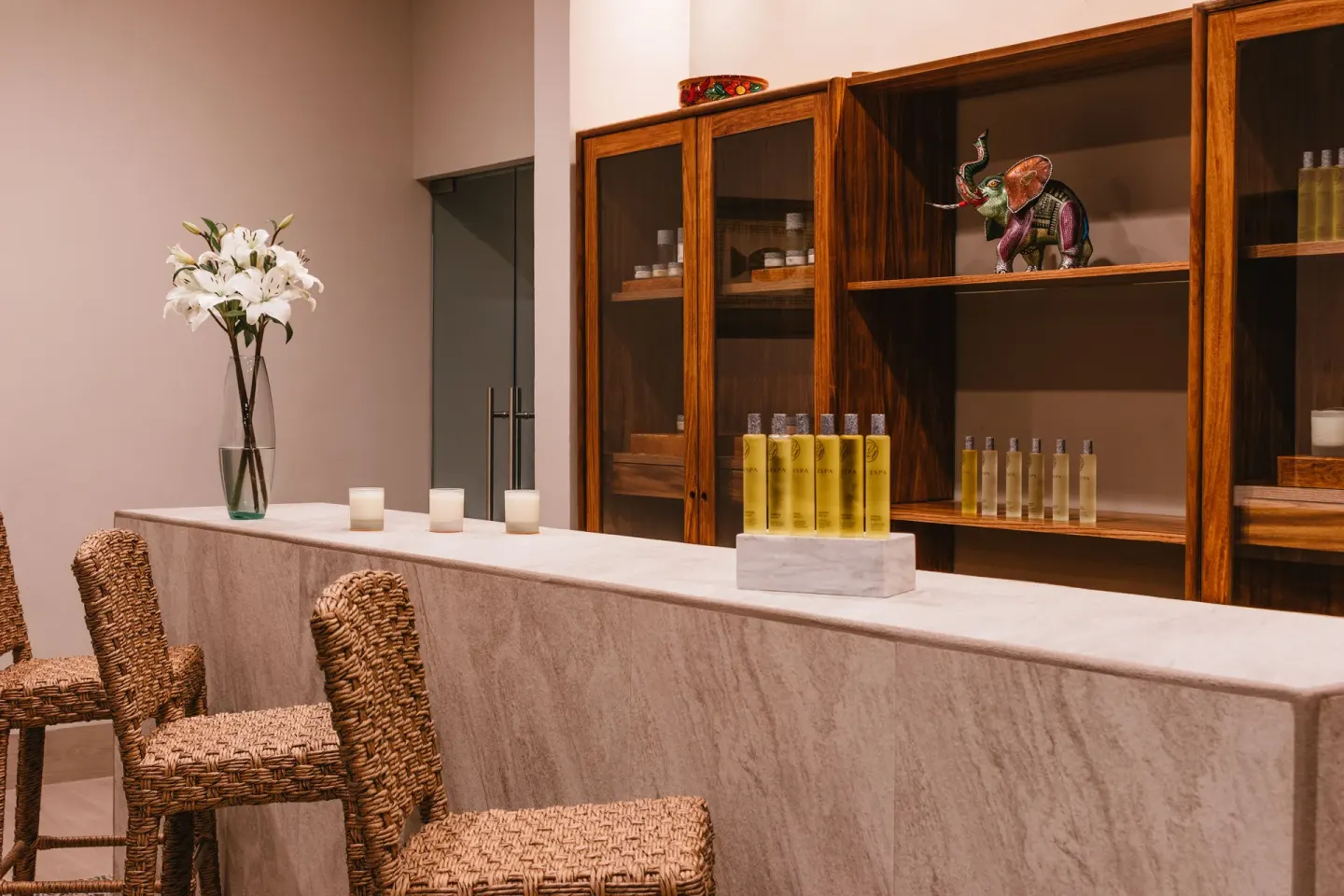 Spa reception counter with candles and bath amenities at Las Brisas Huatulco.